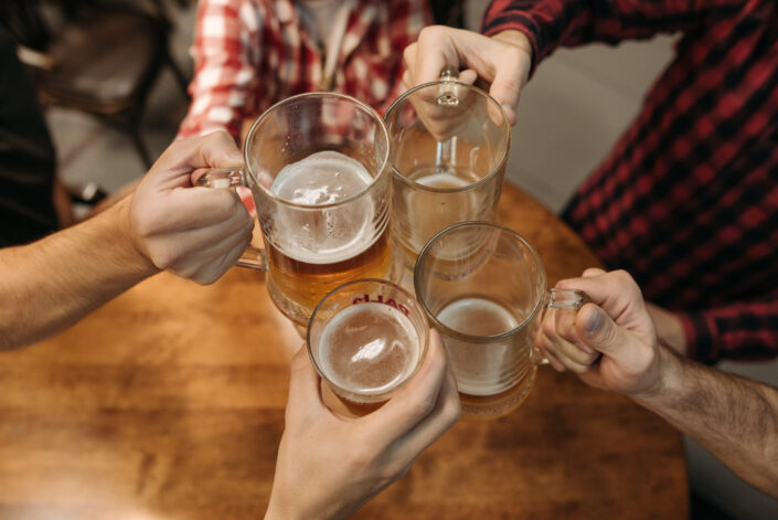 People Toasting Their Beer Mugs